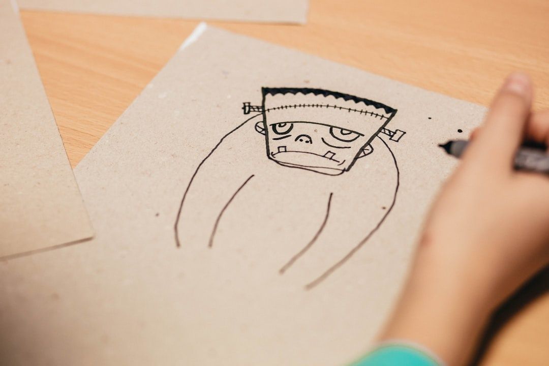 Hand zeichnet ein grimmiges, handgemaltes Monster auf Papier